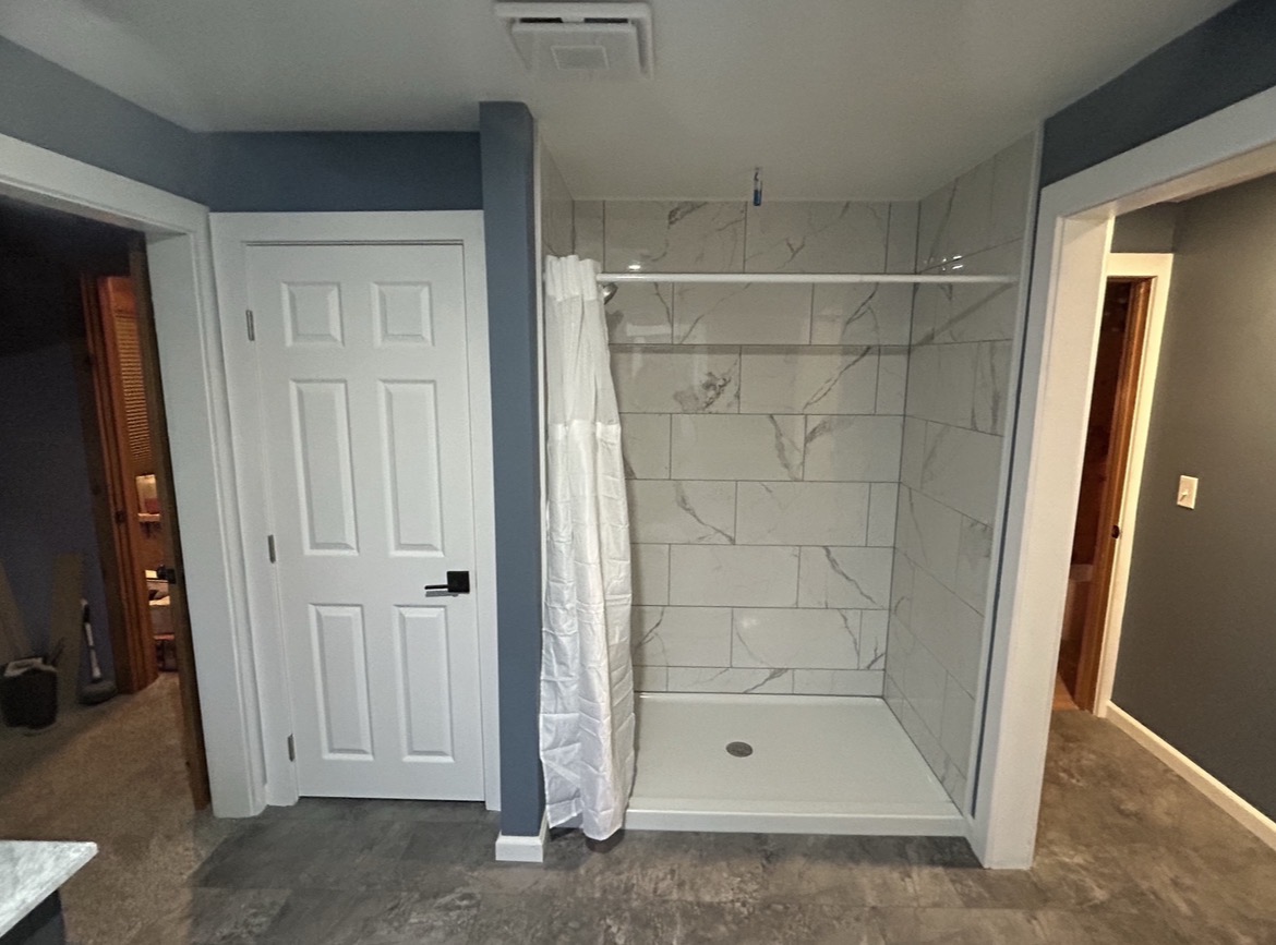 Remodeled bathroom with tiled walk-in shower, by Three Lakes Builders LLC