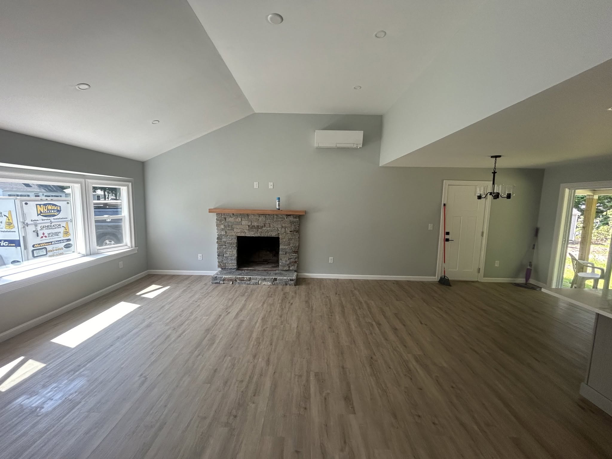 Living room with fireplace and wide windows, posted by Three Lakes Builders LLC
