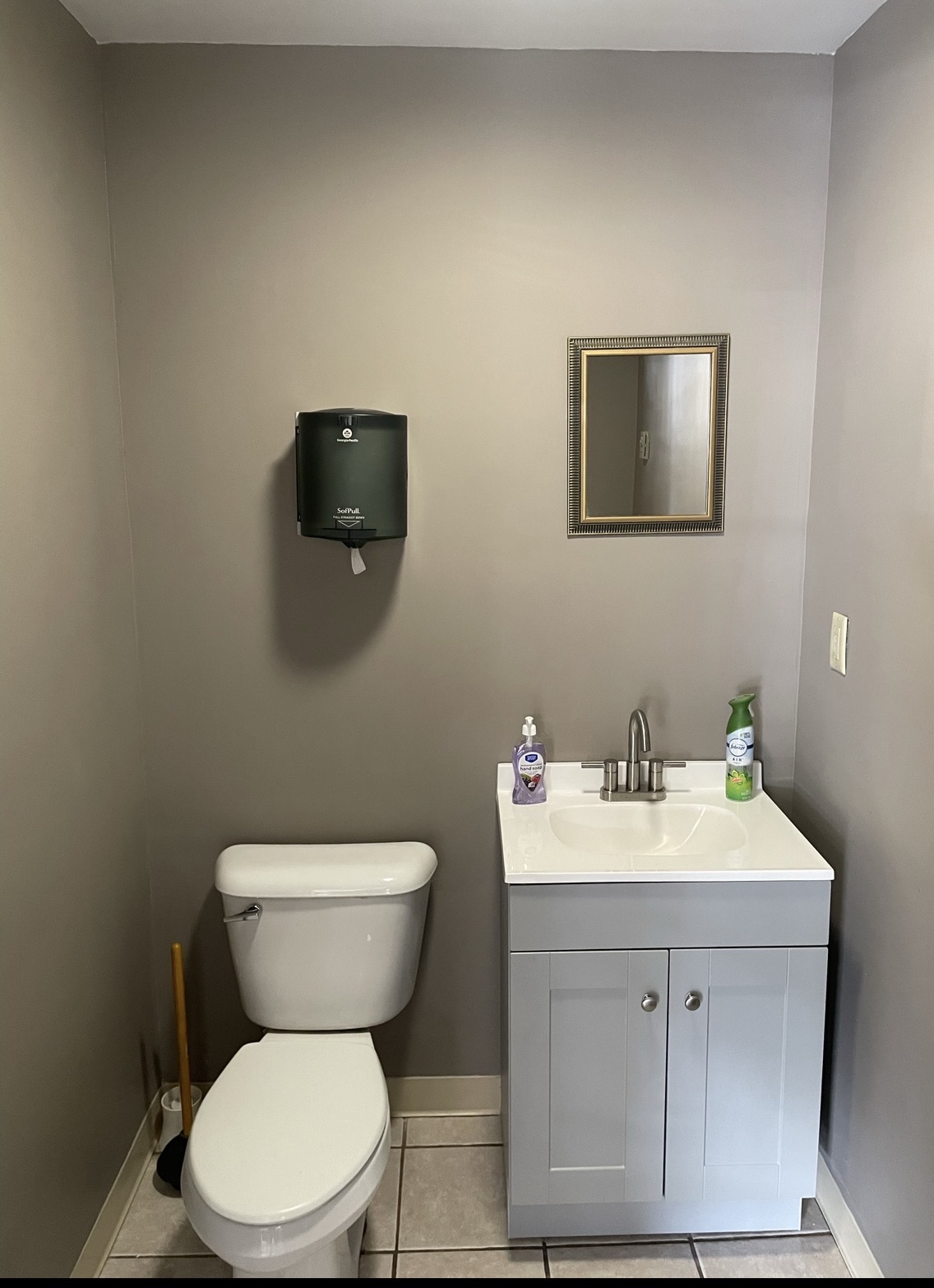 Finished half bathroom with gray walls and white vanity, by Three Lakes Builders LLC